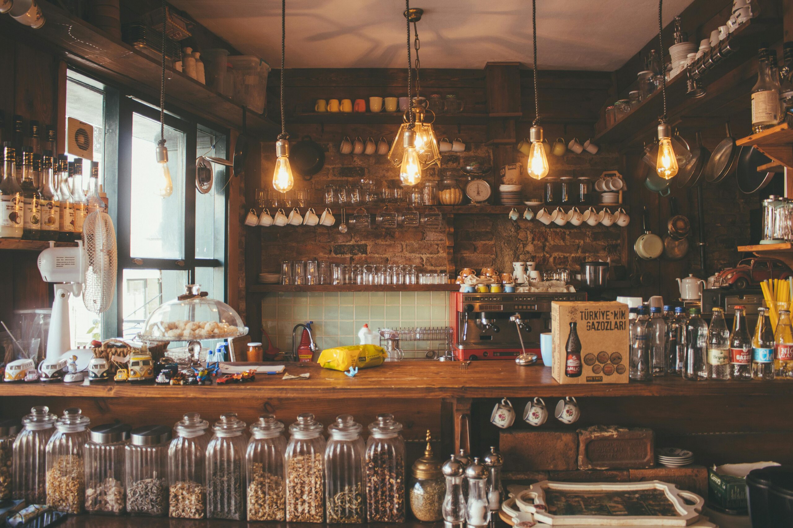 pexels-photo-2079438-2079438 A cozy cafe with rustic decor, pendant lights, and glass jars creates a vintage ambiance.